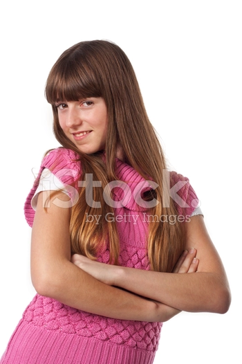 Teen girl standing with arms folded