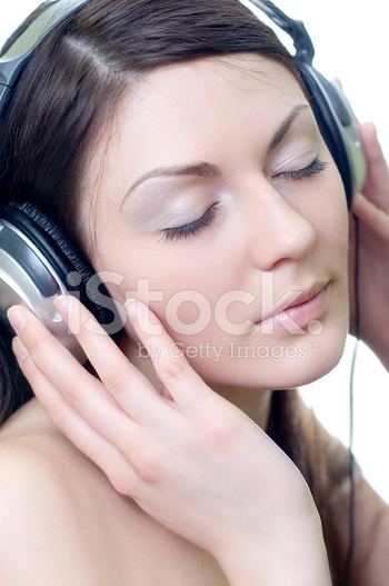 brunette in headphones listens to music